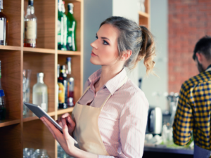 Woman taking inventory at restaurant