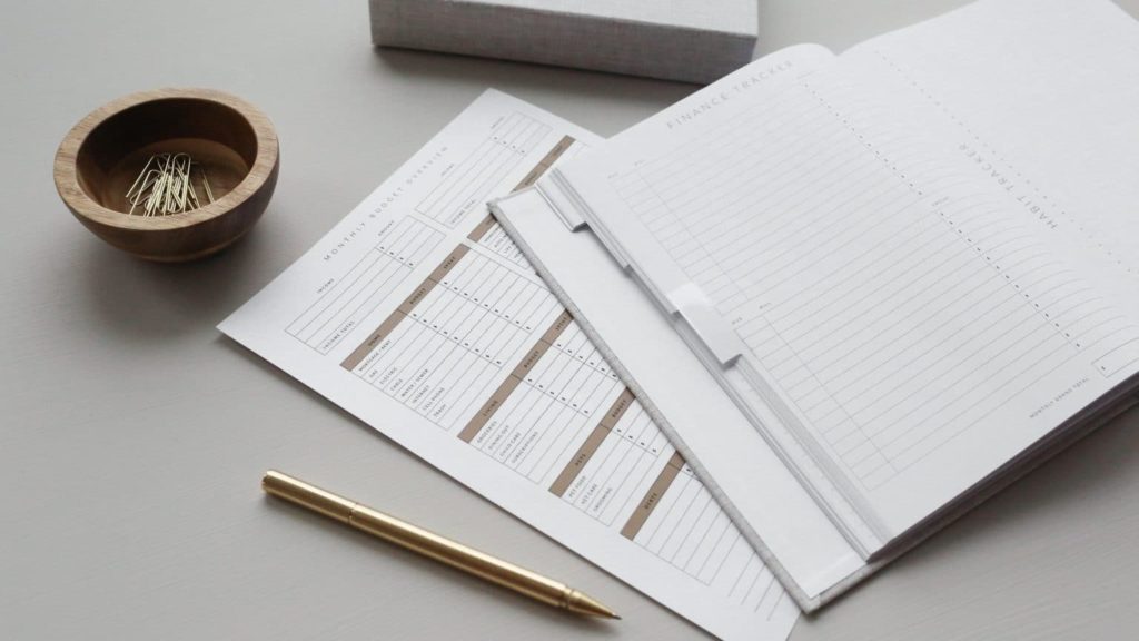 Finance tracker notebook and pen