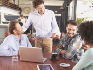 Group in restaurant talking to manager