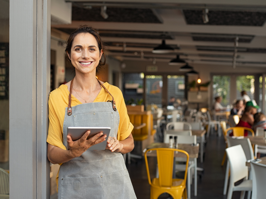 Woman at front of restaurant with tablet
