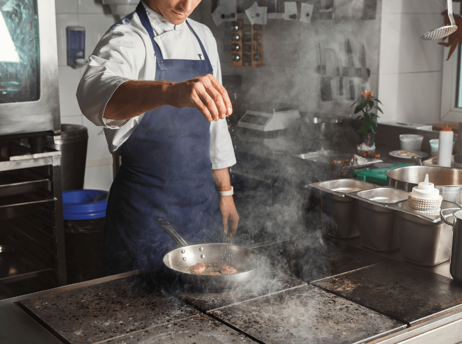 Chef in Kitchen Seasoning Food