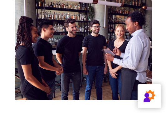 Restaurant manager giving pre-shift talk to employees
