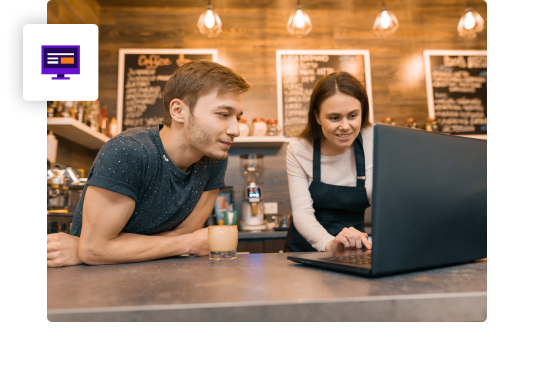 man and woman restaurant employees on laptop behind restaurant counter