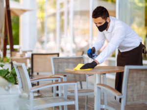 Restaurant employee cleaning table