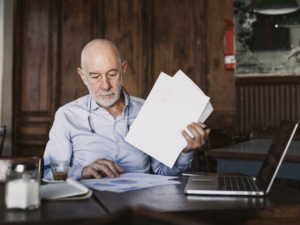 Man reviewing documents at dining table