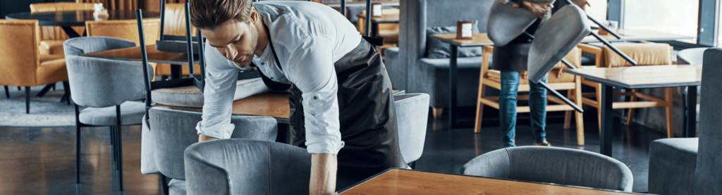 Restaurant worked preparing chairs in dining room