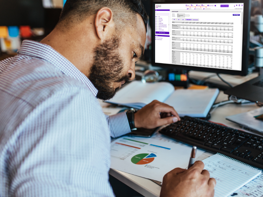 Man Working With RASI Report On Laptop