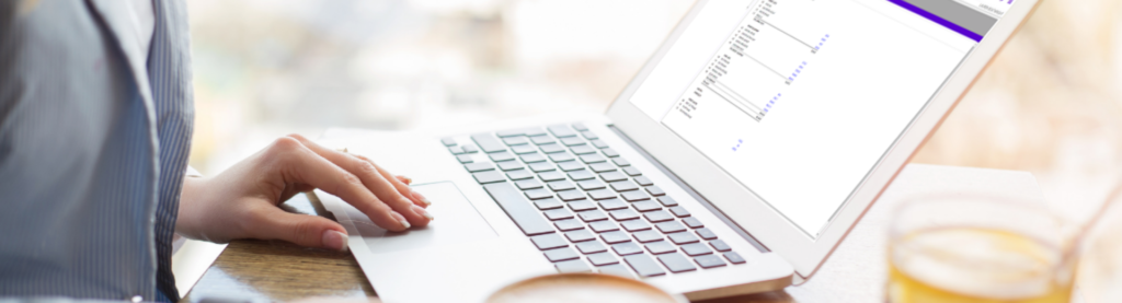 Person reviewing laptop with coffee